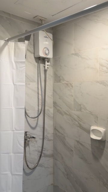 Bathroom shower at Cityscape Grand Tower with marble-patterned tiles